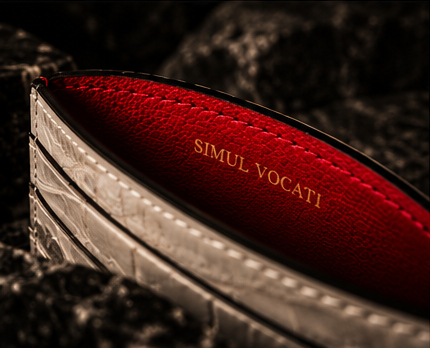 Open cardholder revealing its deep red interior and gold inscription