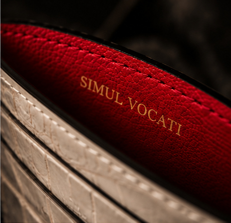 Deep red leather interior with SIMUL VOCATI stamped in gold