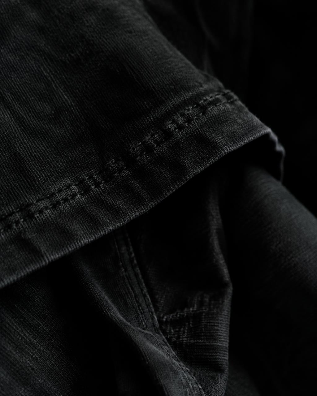 Folded washed black cotton and stitching in shadow